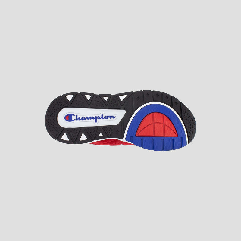 The image shows the sole of the Men's Rally Pro sneaker by Champion, featuring a black tread with white triangular accents, blue and red details, and the Champion logo prominently displayed in the center.