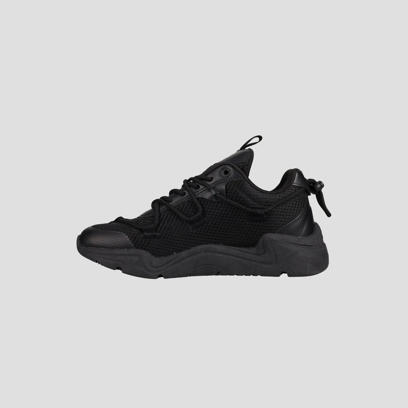 The Champion Men's Hyper C Pilot W is a black lifestyle sneaker featuring a durable mesh upper, leather accents, thick textured sole, lace-up front, and heel pull tab, shown on a plain light gray background.