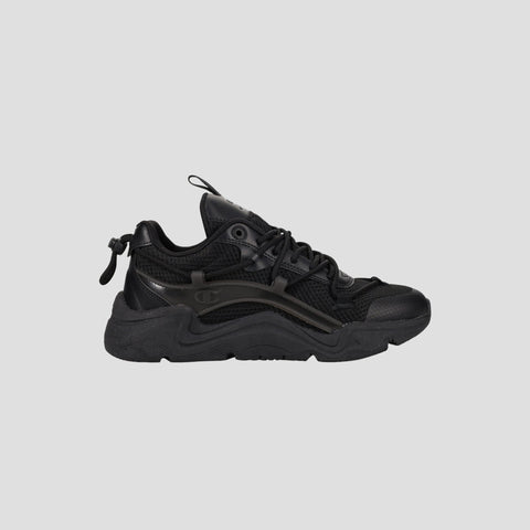 The Champion Men's Hyper C Pilot W is a black lifestyle sneaker with a chunky sole, mesh upper, synthetic overlays, lace-up front, and pull tab at the heel, shown in side profile against a plain light gray background.