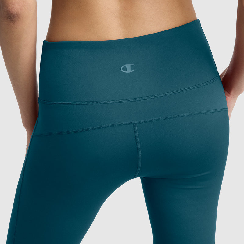 A close-up of a person wearing Champion Soft Touch Flare Leggings with anti-odor technology and a C logo on the waistband, standing against a plain background.