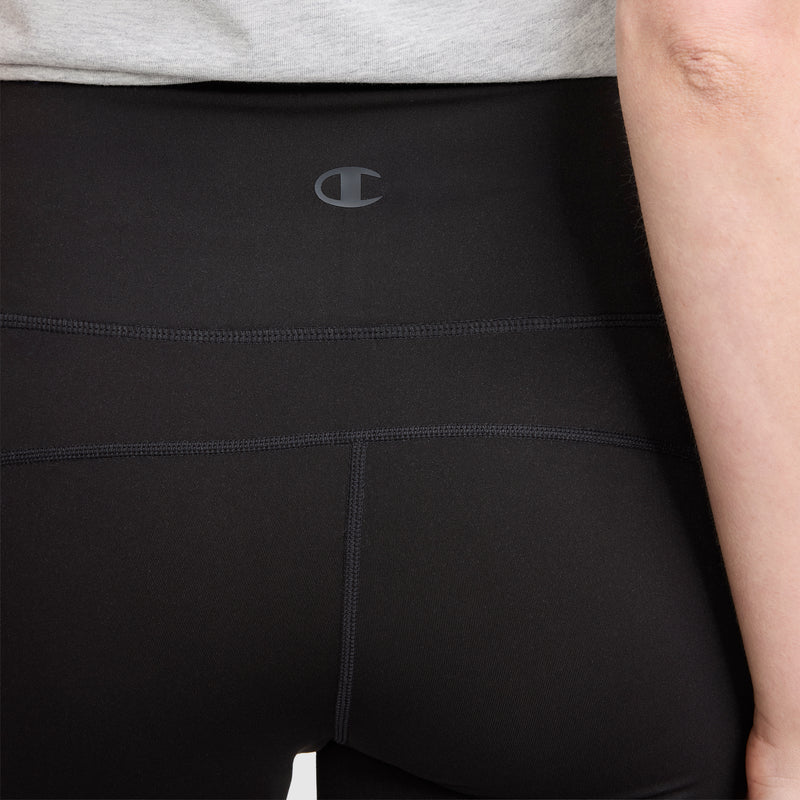 A close-up of a person wearing Champion Soft Touch Flare Leggings with anti-odor technology, featuring visible stitching and a small C logo on the waistband. The person is standing against a plain background.