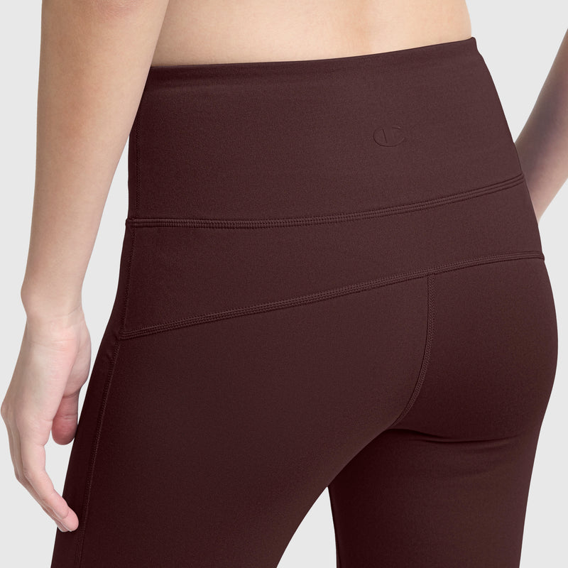 A person is shown from the back and side wearing Champion Soft Touch Flare Leggings with a high-waisted fit, highlighting the anti-odor fabric, textured material, and signature C logo on the waistband.