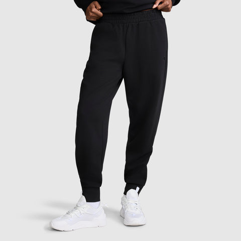 A person wearing the Champion Taper Leg Jogger with Zippers and white sneakers stands against a plain background, with hands partially visible at the waist.