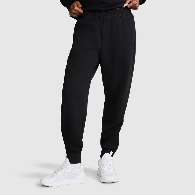 A person wearing the Champion Taper Leg Jogger with Zippers and white sneakers stands against a plain background, with hands partially visible at the waist.
