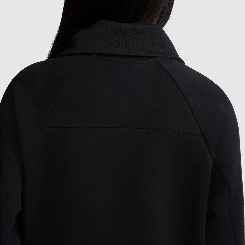 Back view of a person wearing the Champion Quarter-Zip Pullover in black, featuring a wide collar that frames the upper shoulders and neck against a light gray background. The person's partially visible long dark hair emphasizes the pullover’s sleek silhouette.