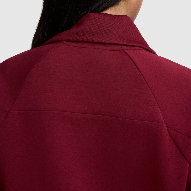 Here's a rewritten version using the given product data: Close-up of a person’s upper back and neck wearing the Champion Quarter-Zip Pullover, made from a stretch scuba fabric in maroon, with straight dark hair visible on the left side against a plain light background.