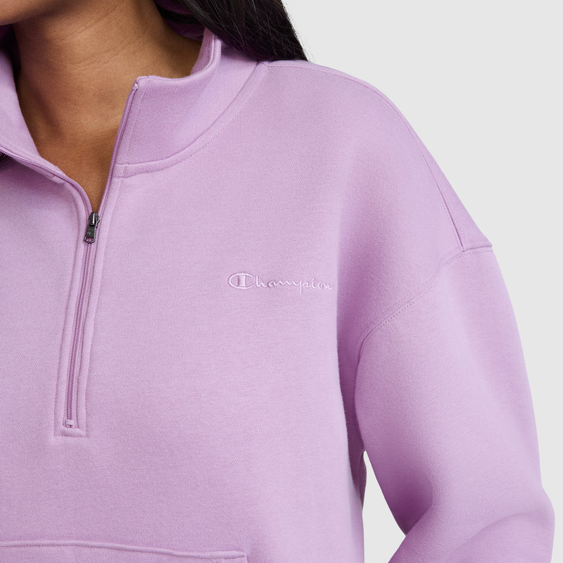 A person wearing a lavender Champion Fleece Mockneck Quarter-Zip. Only the lower face, neck, and upper torso are visible against a plain light background, emphasizing the relaxed Heritage Sport Style of this piece.