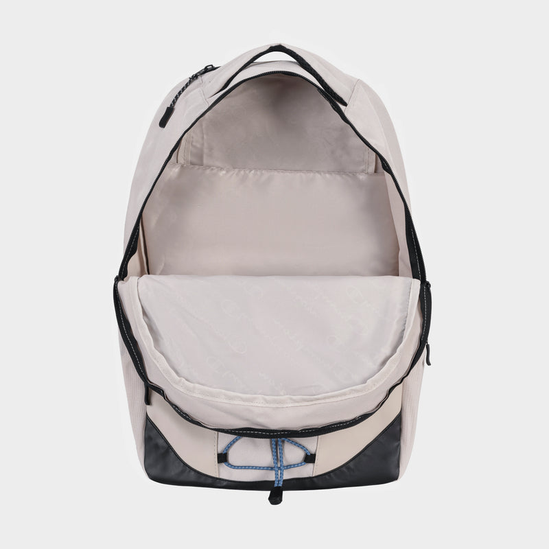 The Champion Summit Backpack in beige features a black bottom, blue drawstring, spacious main compartment, and padded laptop sleeve, displayed open against a white background.