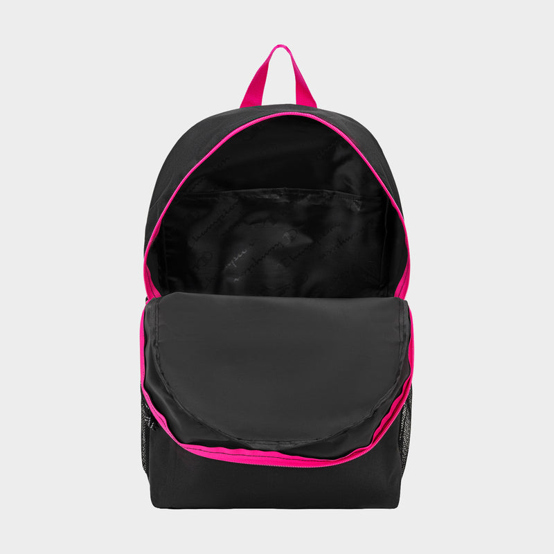 The Champion Kids' Merit Backpack is shown in black with bright pink trim and a pink top handle. Its main compartment is unzipped, displaying an empty, durable polyester interior.