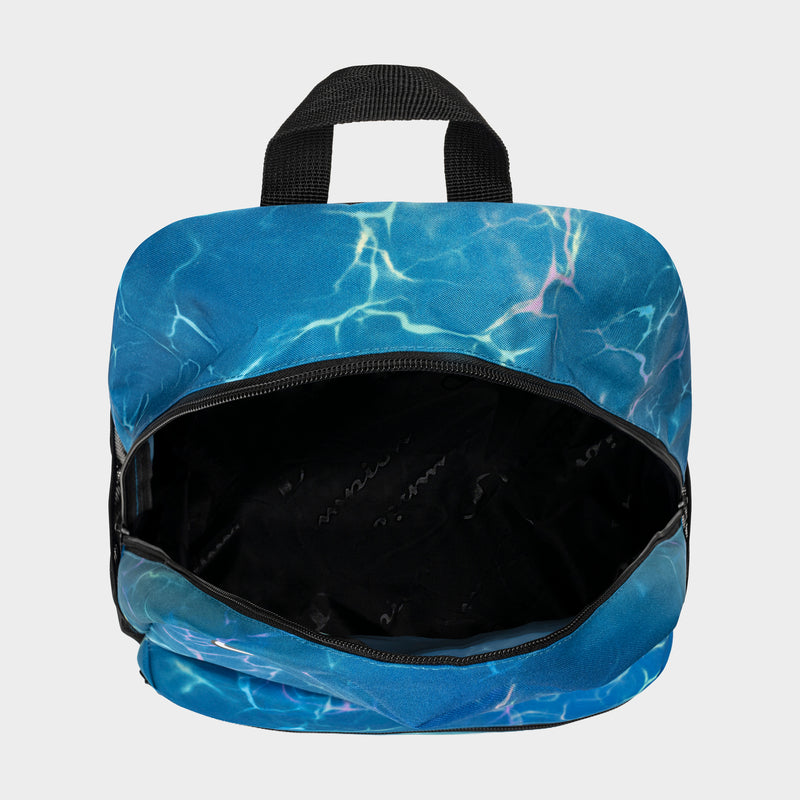 A small Champion Kids' Merit Backpack in blue with a water-inspired pattern and black handle, shown from above with the main compartment open to highlight the spacious interior of this durable kids backpack.
