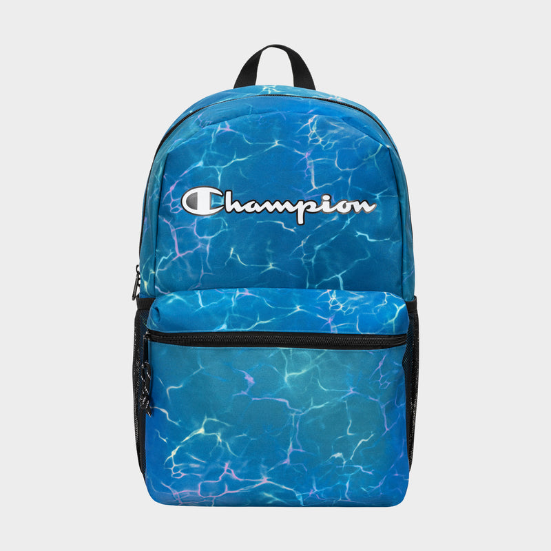 The Champion Kids' Merit Backpack features a blue water ripple design, durable polyester build, large front pocket, black mesh side pockets, and a white Champion logo on top.