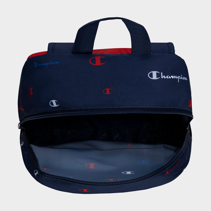 Navy blue Champion lunch bag with a red mesh handle and a repeating Champion logo pattern in red, white, and blue. Pair it with the durable Kids' Merit Backpack by Champion for a matching set. The bag’s insulated interior is empty.