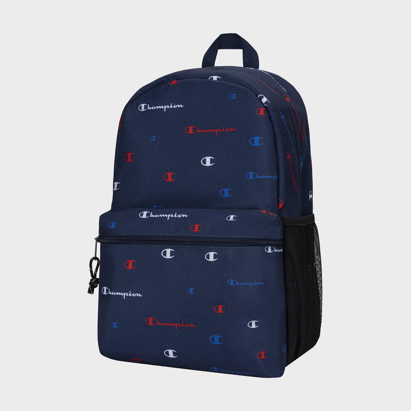 The Champion Kids' Merit Backpack features a navy blue design with red, white, and blue all-over Champion logos, plus a front zip pocket and mesh side pocket—a durable option for youth.