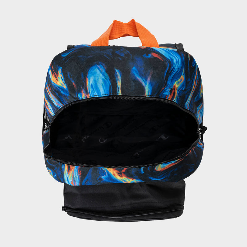 The Champion Kids' Mode Lunch Kit & Backpack Combo features a vibrant blue, orange, and black swirl pattern with an orange handle and spacious main compartment. The bottom is solid black and partially unzipped in the image.
