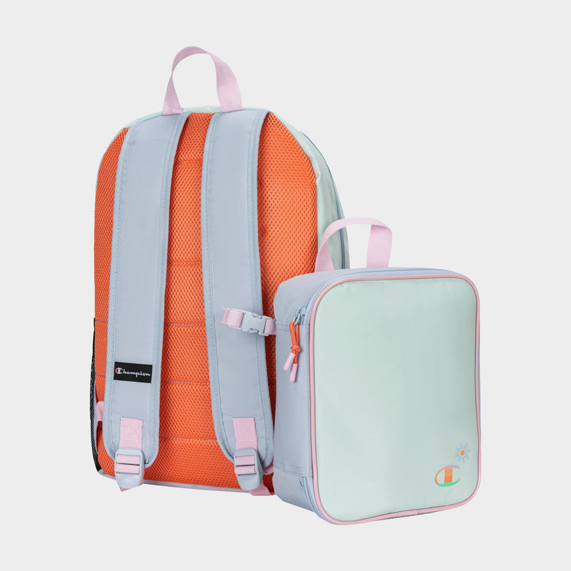 The Champion Kids' Mode Lunch Kit & Backpack Combo features a pastel blue and pink backpack with orange padded straps, plus a matching insulated lunch box. Both display the iconic Champion branding and are shown on a light background.