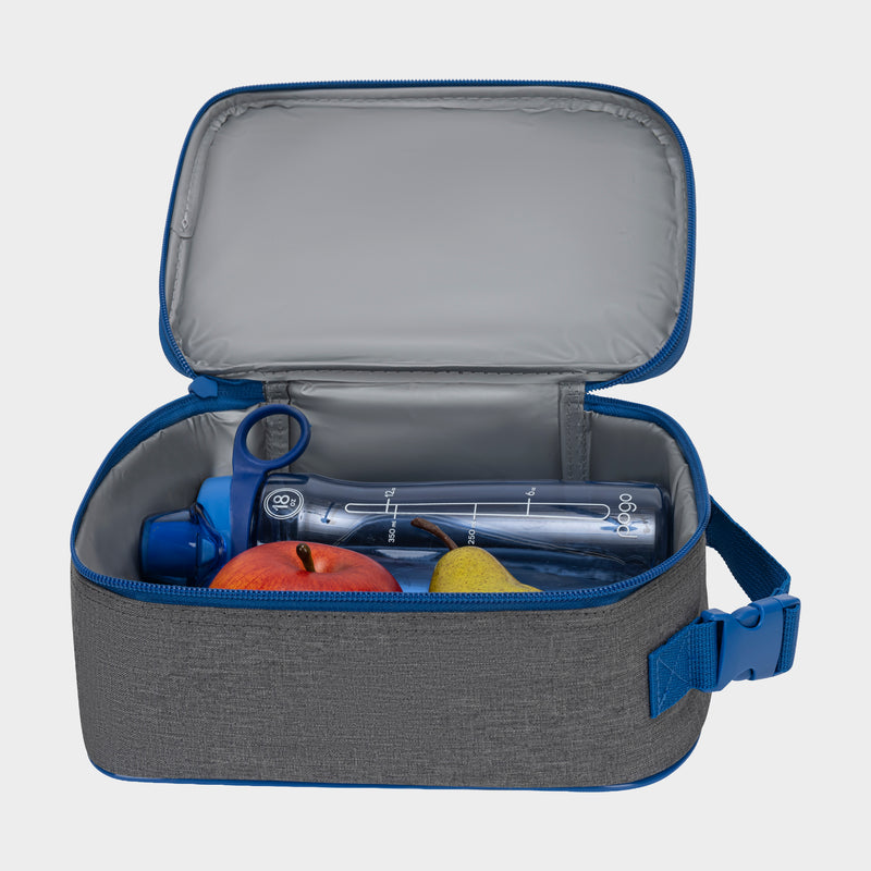 The Champion Kids' Merit Lunch Box, gray with a blue zipper and strap, is open to show a clear water bottle, red apple, and yellow pear inside. Its durable build keeps food fresh against a plain backdrop.