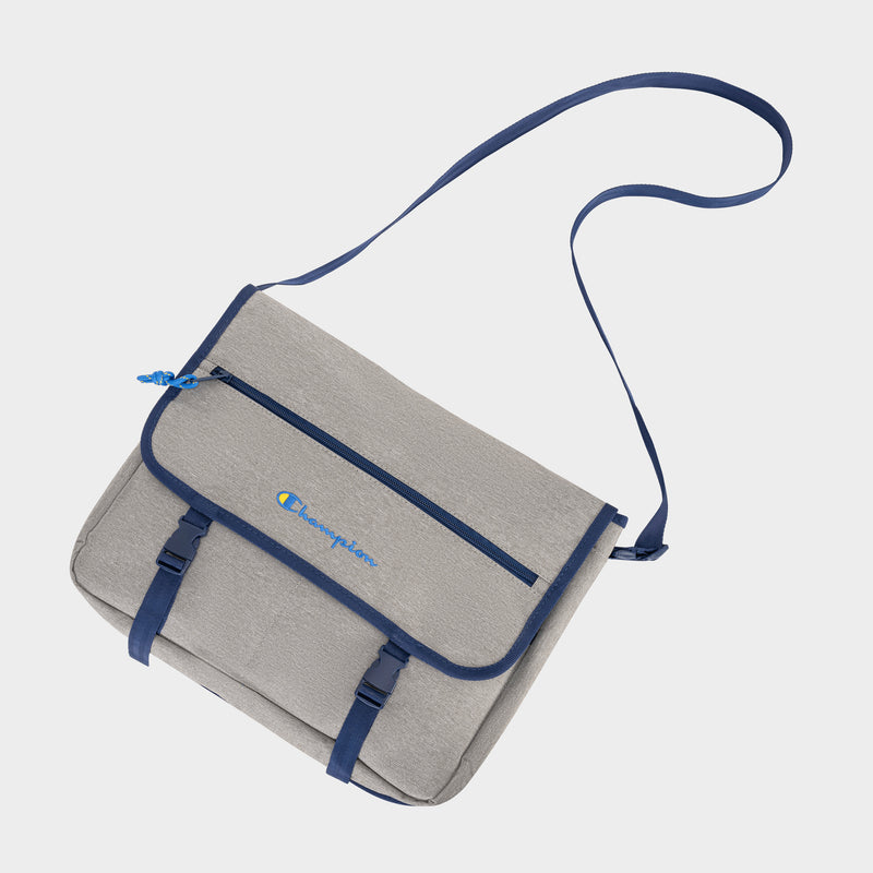 The Champion Phase Messenger Bag features a gray design with blue accents, an adjustable shoulder strap, front zipper pocket, buckle closures, internal laptop sleeve, and a small embroidered Champion logo on the front flap.