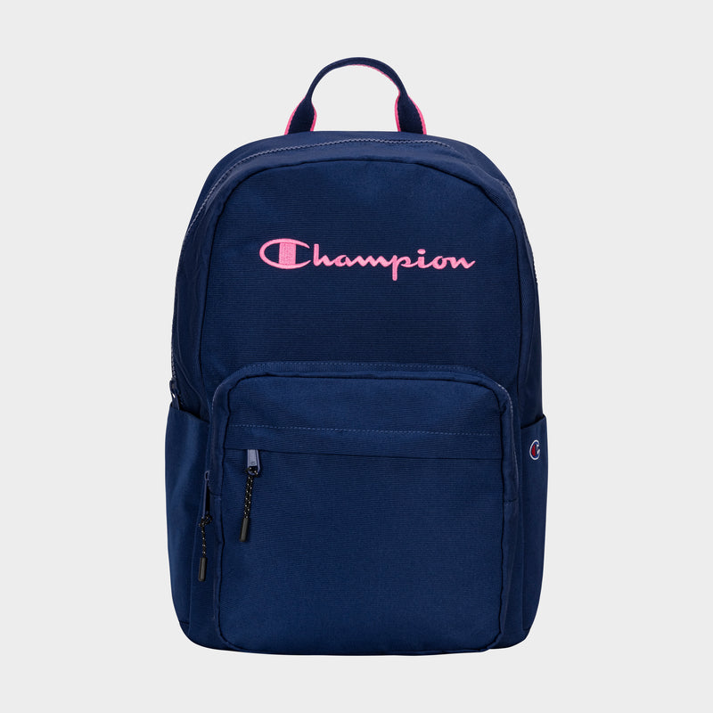 The Champion Steady Backpack is navy blue with a pink embroidered logo, front zip pocket, side pocket, top handle, and dual zipper pulls for easy main compartment access.
