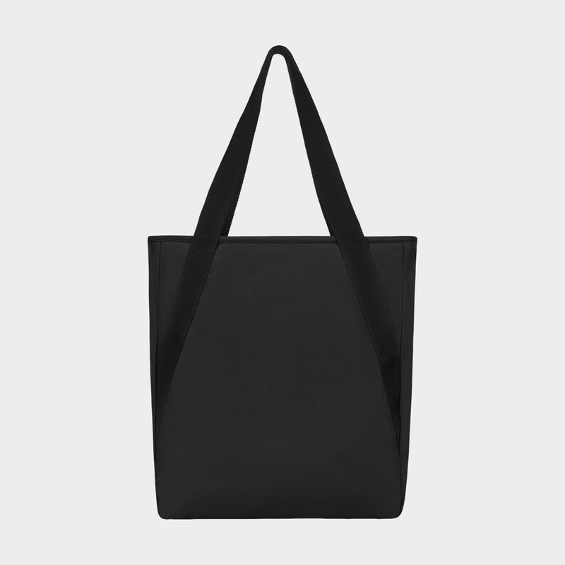 The Champion Lottie Tote is a plain black tote bag with two long handles, displayed against a white background. Featuring a minimalist design with no visible logos or patterns, this everyday essential bag combines versatility and style.