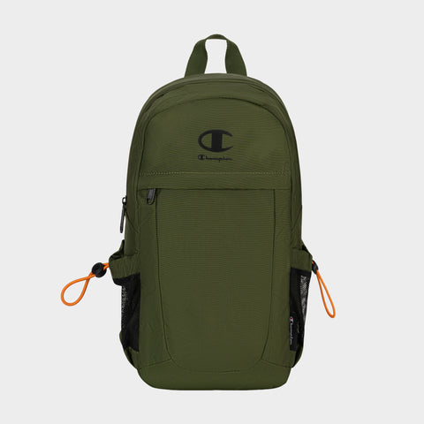The Champion Camden Sling backpack, shown in olive green with a black logo, features front zip pocket, side mesh pockets, and orange zipper pulls. Made from durable nylon material, this sling bag includes an adjustable strap for comfortable carrying and is displayed on a plain light background.