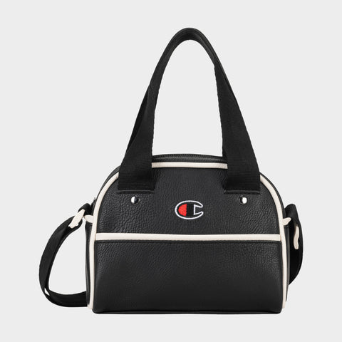 Hudson Mini Bowler Bag: This compact black handbag by Champion features white trim, dual handles, and an adjustable strap for versatile carrying options. The front displays the iconic Champion logo with a red, white, and blue “C.” The Hudson Mini Bowler Bag offers a zippered top closure, a convenient front pocket, and an interior zip pocket to keep your essentials organized.