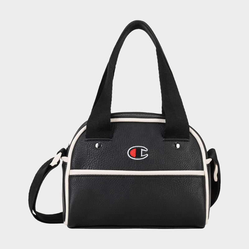 Hudson Mini Bowler Bag: This compact black handbag by Champion features white trim, dual handles, and an adjustable strap for versatile carrying options. The front displays the iconic Champion logo with a red, white, and blue “C.” The Hudson Mini Bowler Bag offers a zippered top closure, a convenient front pocket, and an interior zip pocket to keep your essentials organized.