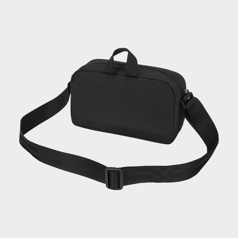 The Champion Explore Crossbody, crafted from durable black nylon, features a wide adjustable strap and two small handles, and is displayed on a plain light background.