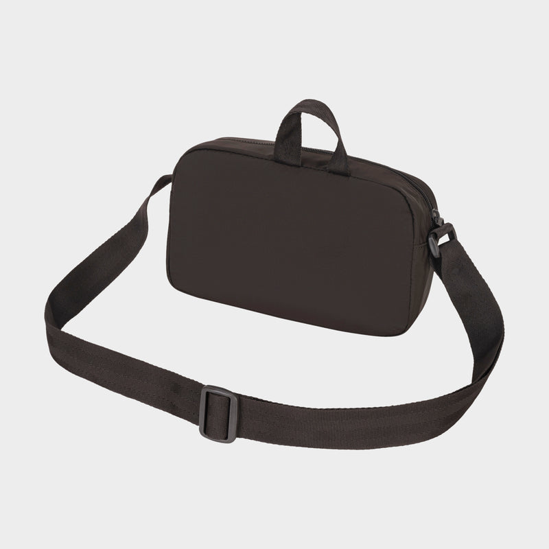 The Champion Explore Crossbody is a black rectangular bag made from durable crinkle nylon, featuring a long adjustable strap for hands-free use and two small top handles, shown against a plain white background.