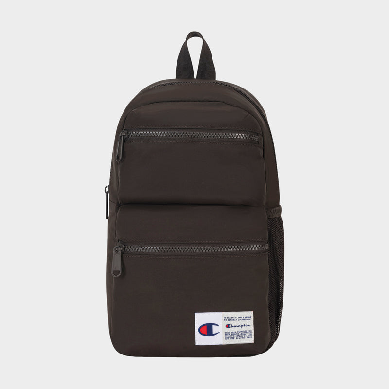 Introducing the Champion Explore Sling—a compact black sling bag featuring two front zippered pockets, a mesh side pocket, and a white Champion logo patch on the lower front. Designed for those who prefer to travel light, this sleek carry includes a top handle and black zippers, blending practical everyday utility with classic Champion style.