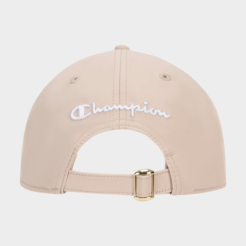 The Champion Lifestyle Sport Adjustable Baseball Cap in beige is shown from the back, with white embroidered text above an adjustable strap and gold buckle—highlighting its classic athletic heritage style.