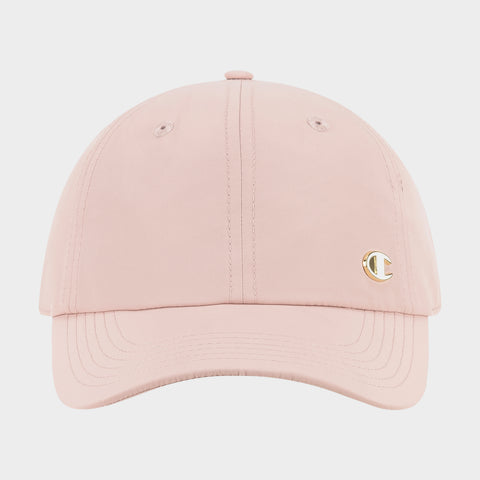 The Champion Lifestyle Sport Adjustable Baseball Cap features a light pink design, visible stitching, and a small gold C logo on the right front panel, offering everyday style and an adjustable fit. Displayed against a plain white background.