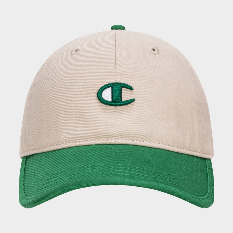 The Champion Briggs Washed Cotton Twill Adjustable Baseball Cap features a beige design with a green brim and a green and white embroidered C logo, crafted from washed cotton twill and shown on a plain white background.
