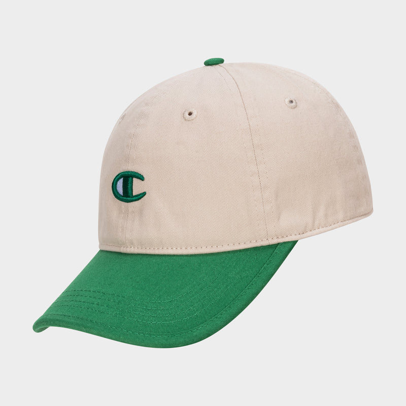 The Briggs Washed Cotton Twill Adjustable Baseball Cap by Champion features a beige crown, green brim, and a green embroidered C logo on the front, shown at an angle against a white background for vintage style.