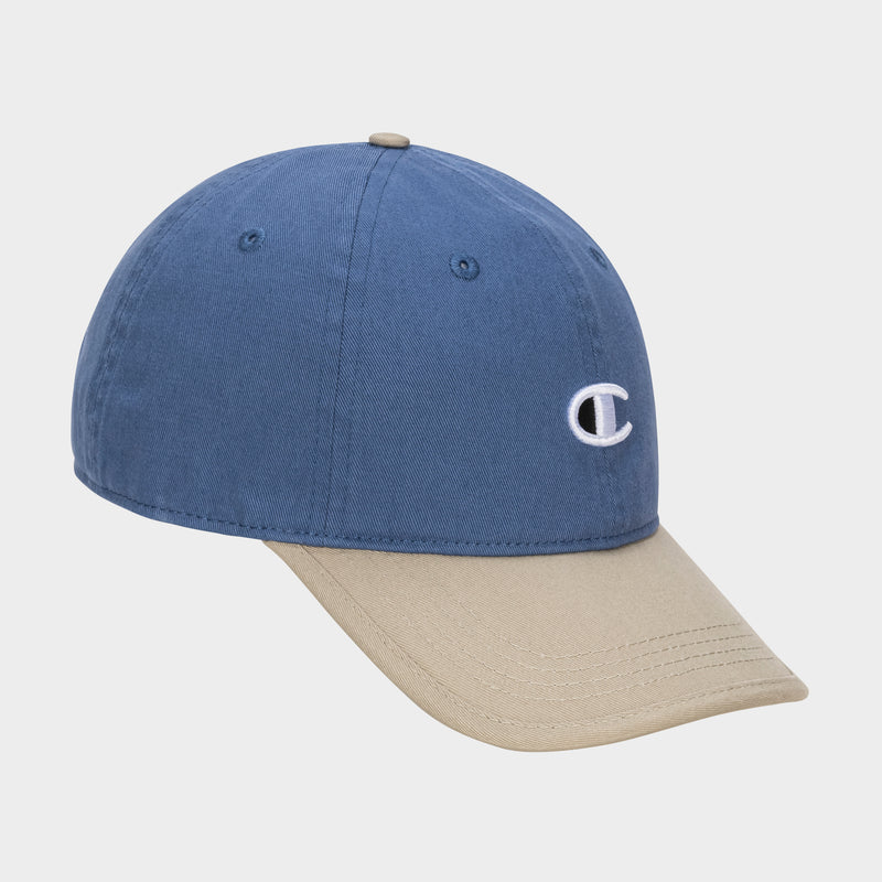 The Briggs Washed Cotton Twill Adjustable Baseball Cap by Champion features a blue crown, beige brim, and a white embroidered C logo on the front. Photographed on a plain white background for vintage appeal.