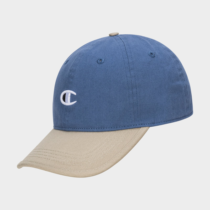 The Briggs Washed Cotton Twill Adjustable Baseball Cap by Champion features a blue crown, beige brim, and an embroidered white C logo on the front, offering vintage style against a simple light background.