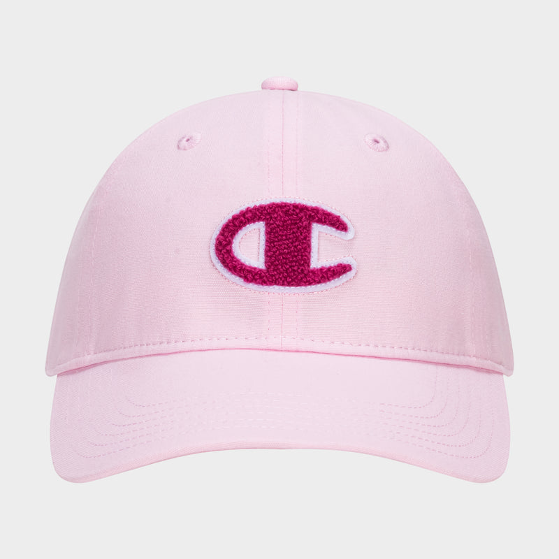 The Champion Amber Chenille Adjustable Baseball Cap in light pink slub canvas features a large, textured dark pink C logo chenille patch outlined in white on the front, with visible stitching and an unconstructed fit.