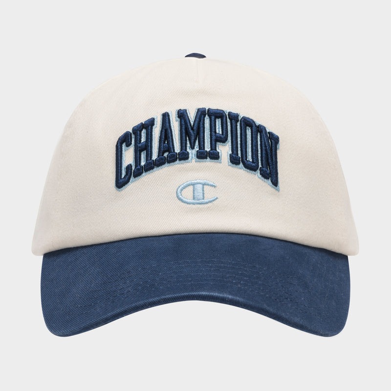 The Champion Amor Adjustable Baseball Cap features beige cotton twill, a dark blue brim, "CHAMPION" embroidered in blue on the front, and a light blue Champion logo.