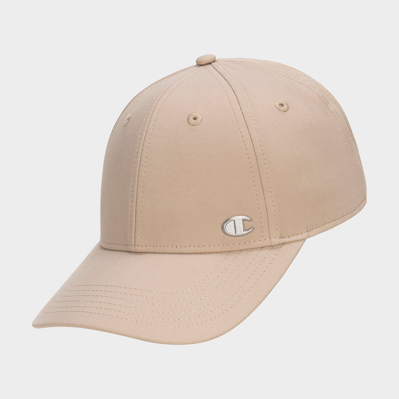The Champion Ponytail Baseball Cap is beige with a curved brim, made from performance stretch fabric, and features a silver C logo on the front. It’s displayed against a plain white background.