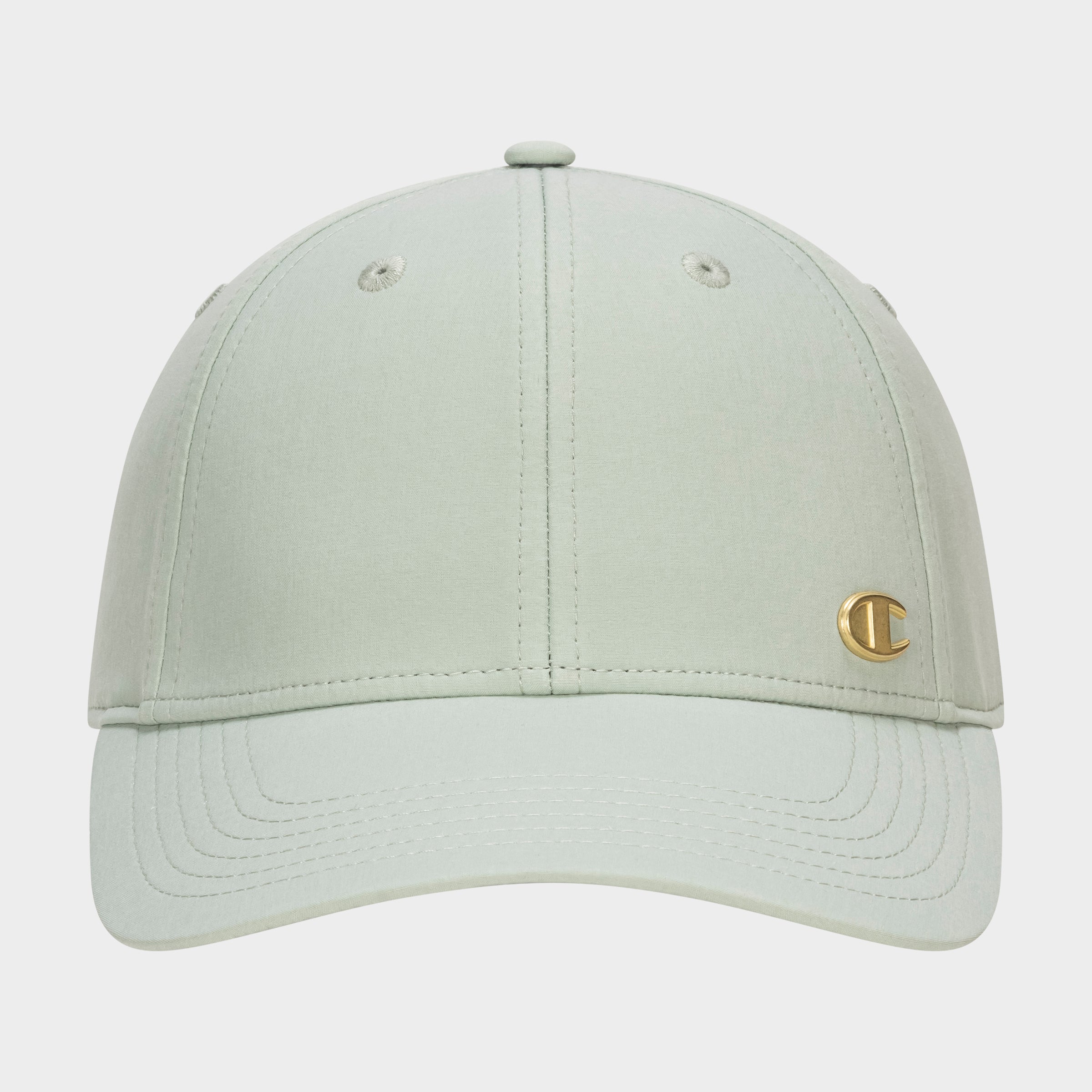 Front view of the Champion Ponytail Baseball Cap in light sage green, featuring a curved brim, performance stretch fabric, and a small gold C logo emblem on the lower right front panel.