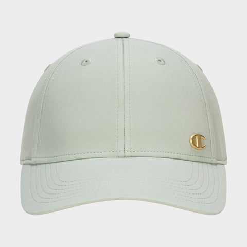 Front view of the Champion Ponytail Baseball Cap in light sage green, featuring a curved brim, performance stretch fabric, and a small gold C logo emblem on the lower right front panel.