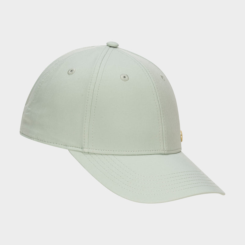 The Champion Ponytail Baseball Cap in light green features stitched panels, ventilation eyelets, and a curved brim, displayed on a plain white background.