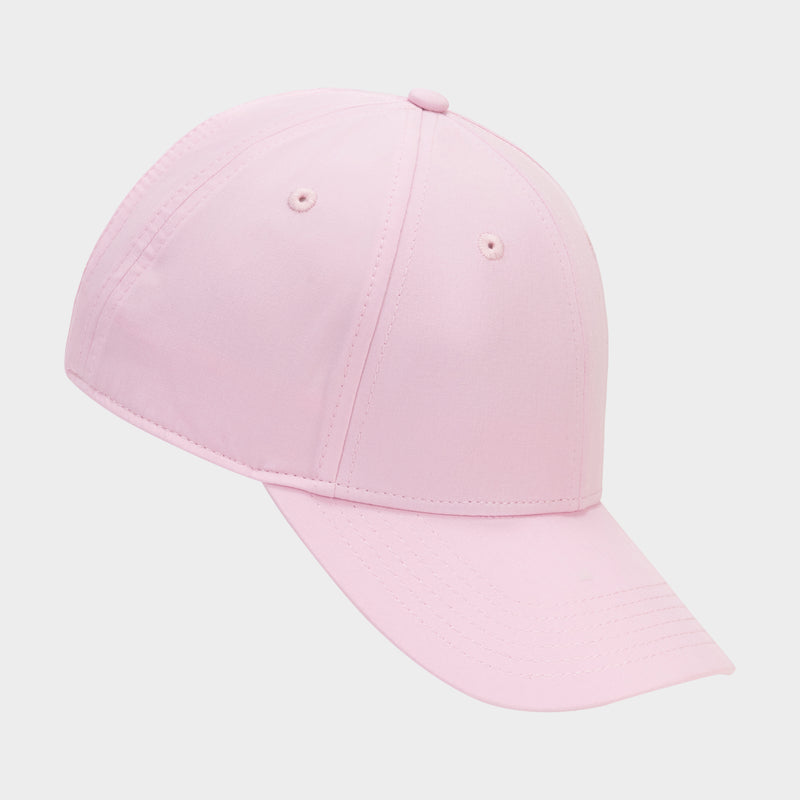 The Champion Ponytail Baseball Cap features light pink performance stretch fabric, visible stitching, ventilation eyelets, and a ponytail-friendly design, shown on a neutral background.