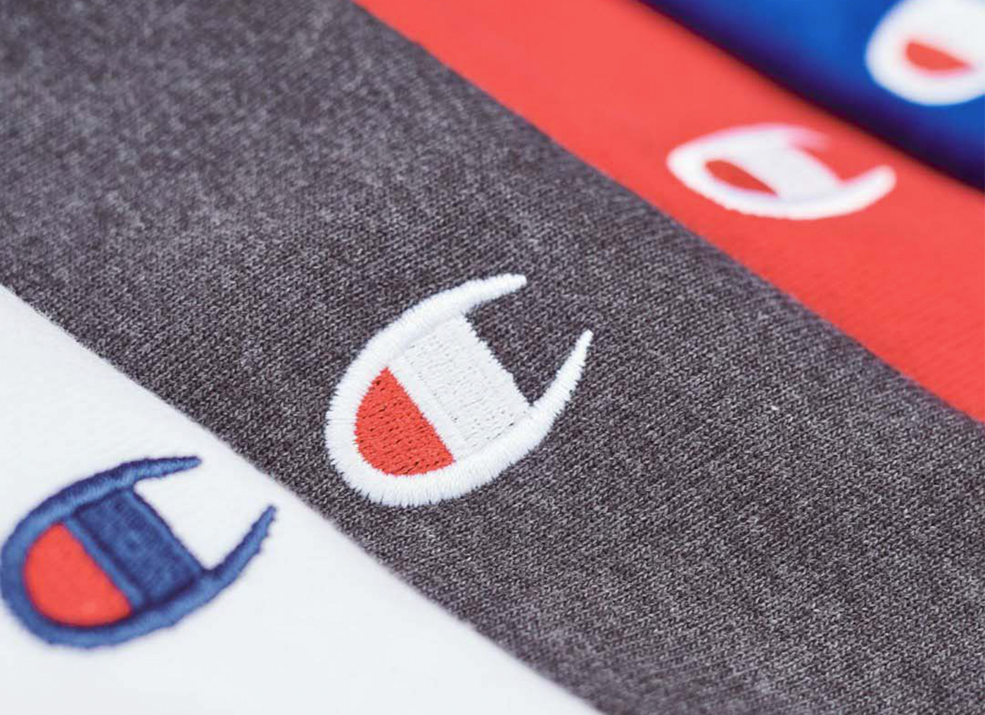 Close-up of Champion logo on various sweatshirts