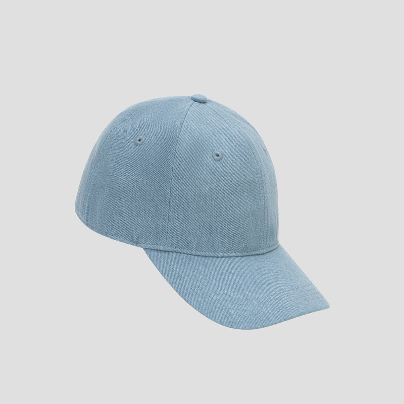 The Glen Denim Adjustable Baseball Cap by Champion features a light blue denim design and a curved brim, shown here from a slight angle on a plain white background. This versatile cap offers classic style and everyday comfort—an ideal accessory to complement any casual outfit.