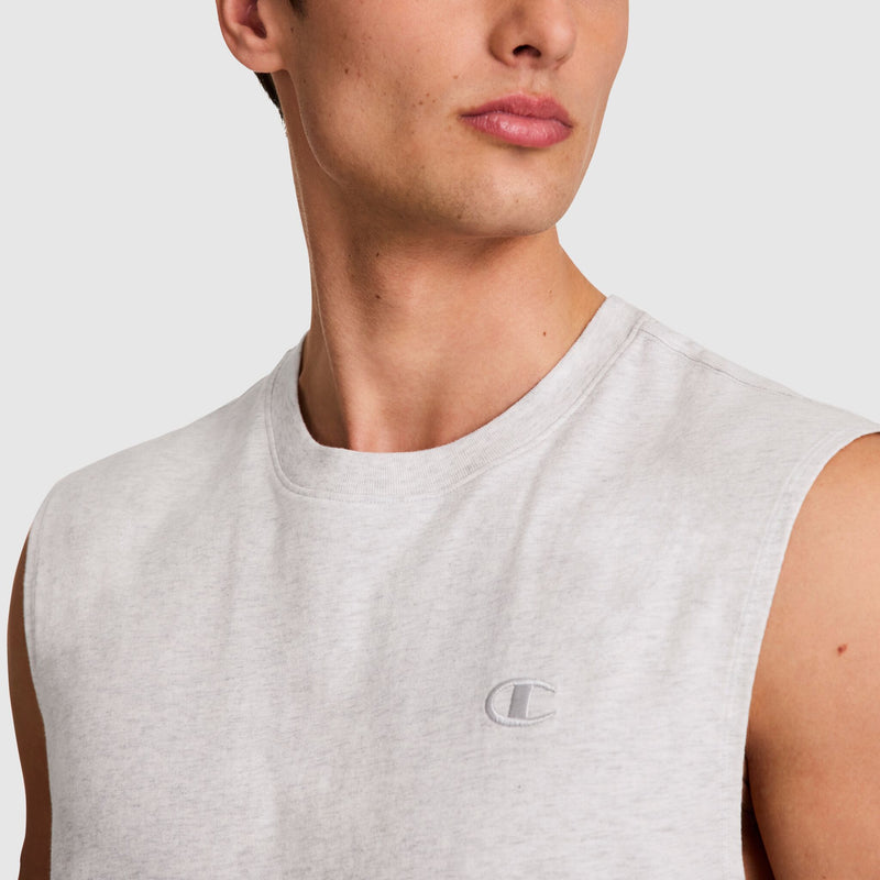 A person wears the Champion Muscle Tank, C Logo, in light gray, featuring a small embroidered C logo on the chest, shown from the shoulders up against a plain background.