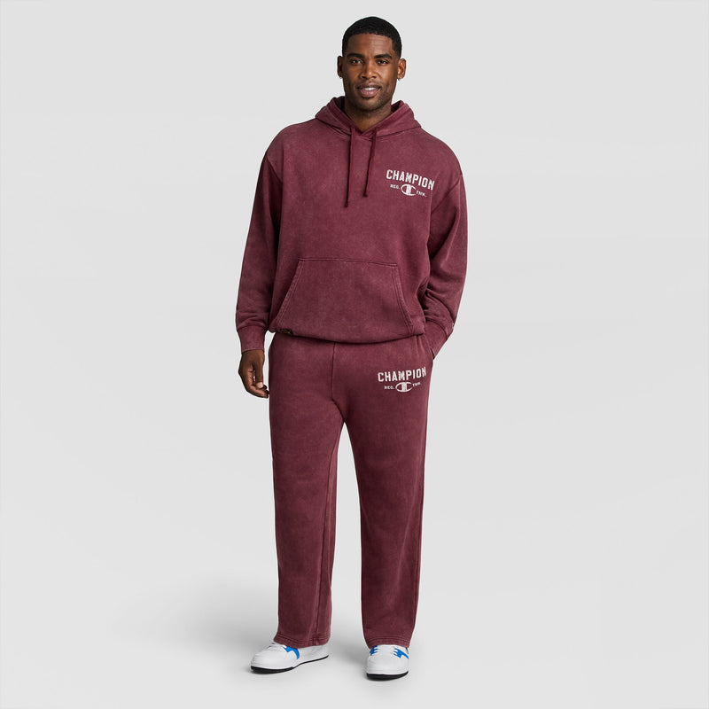A person wears a matching dark red mineral wash hooded sweatshirt and Champion Mineral Wash Open Hem Pant with white lettering.