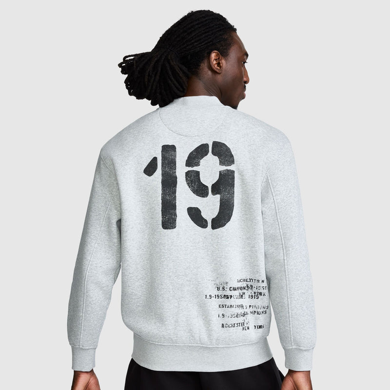 Back view of a light gray Champion Fleece Baseball Jacket with the number 19 printed in large, distressed black font on the back, along with smaller distressed text at the lower right.