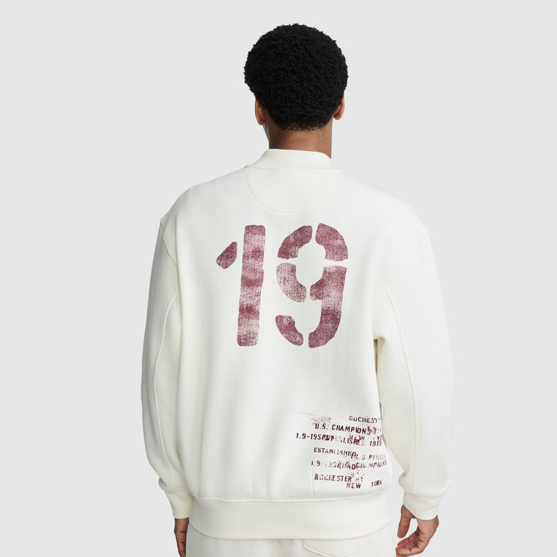 Back view of an off-white Champion Fleece Baseball Jacket featuring large distressed 19 numerals and smaller vintage athletic text on the lower back.
