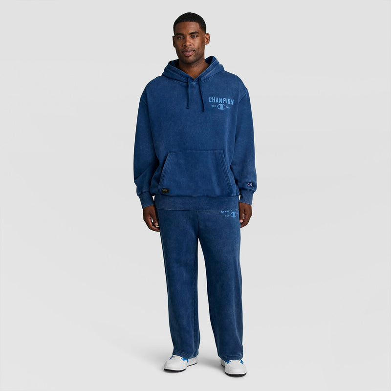 A man wearing a Mineral Wash Pullover Hoodie, C Patch Logo in blue with matching sweatpants.