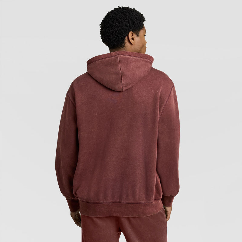 A person seen from the back wearing a dark red Mineral Wash Pullover Hoodie, C Patch Logo.